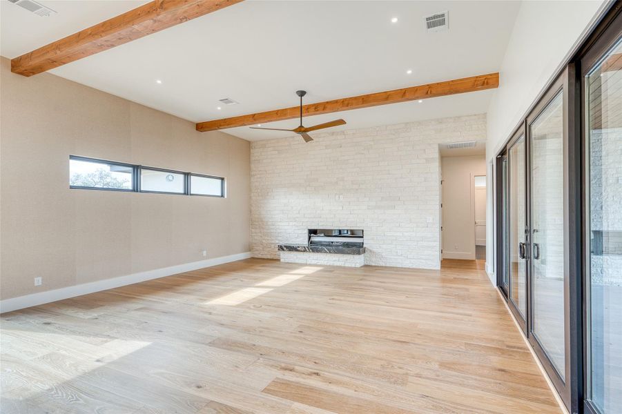 Family room is open to kitchen & dining areas and features a 72”linear gas fireplace and floor to ceiling stone wall. Open to spacious outdoor living area and courtyard