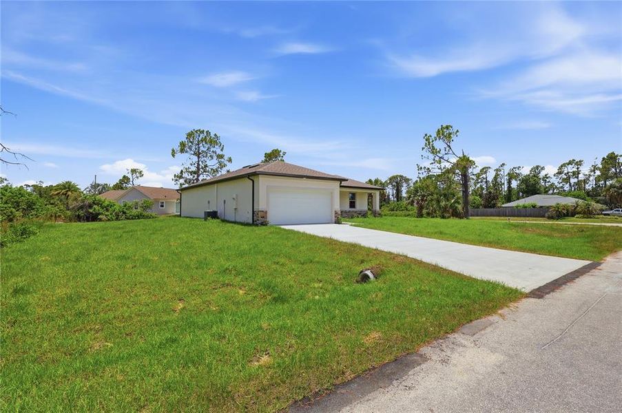 Front exterior of a new home in , North Port, FL, highlighting curb appeal (Image 22). Front exterior of a new home in , North Port, FL, highlighting curb appeal (Image 22).