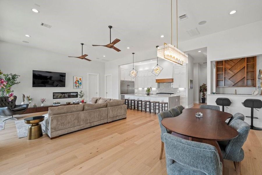 Bright, airy, and beautifully designed—this open-concept living space features a designer kitchen, custom bar nook, elegant dining area, and cozy living room with modern touches throughout. Perfect for effortless entertaining and everyday comfort at Canyon Lake.