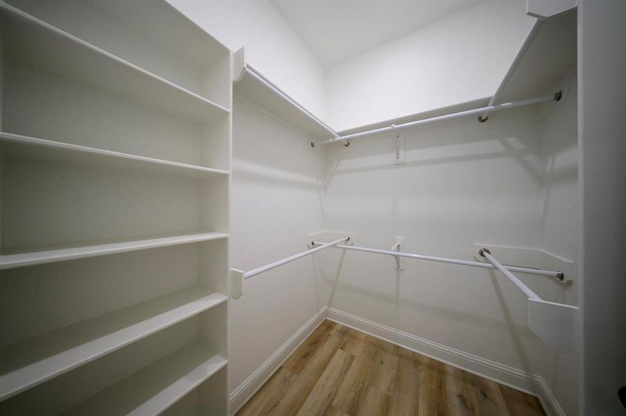 Spacious closet featuring light wood-style floors Spacious closet featuring light wood-style floors