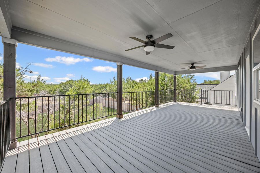 Wooden deck with a ceiling fan, a patio area, and view of scattered trees Wooden deck with a ceiling fan, a patio area, and view of scattered trees
