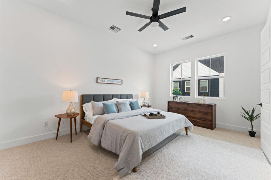 This spacious primary bedroom is perched on the second floor, offering a peaceful escape with elevated views and abundant natural light. Designed with comfort and style in mind, the room features soft neutral tones, plush carpeting or hardwood floors, and ample space for a king-size bed and cozy seating area. Large windows frame the surroundings, while thoughtful touches like recessed lighting and a walk-in closet add to the luxurious feel. A serene sanctuary that blends privacy with sophistication.