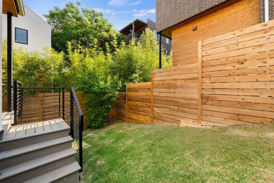 Fenced backyard with a wooden deck