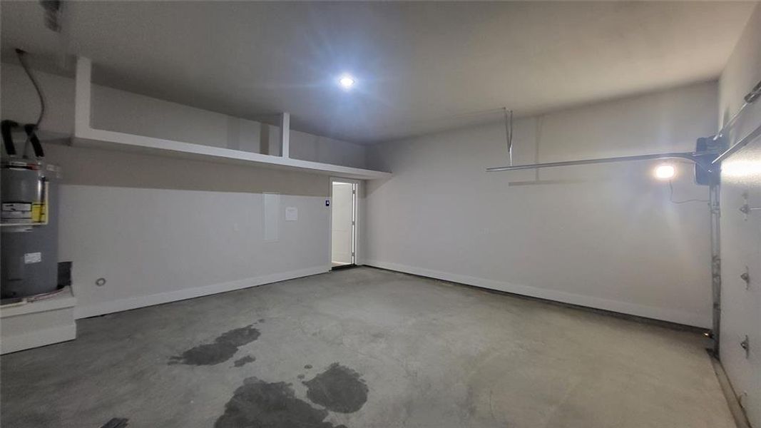 Garage with water heater and baseboards