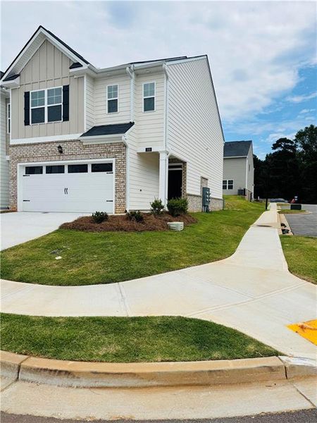 Front exterior of a new home in Inverness at Sugarloaf, Lawrenceville, GA, highlighting curb appeal (Image 2).