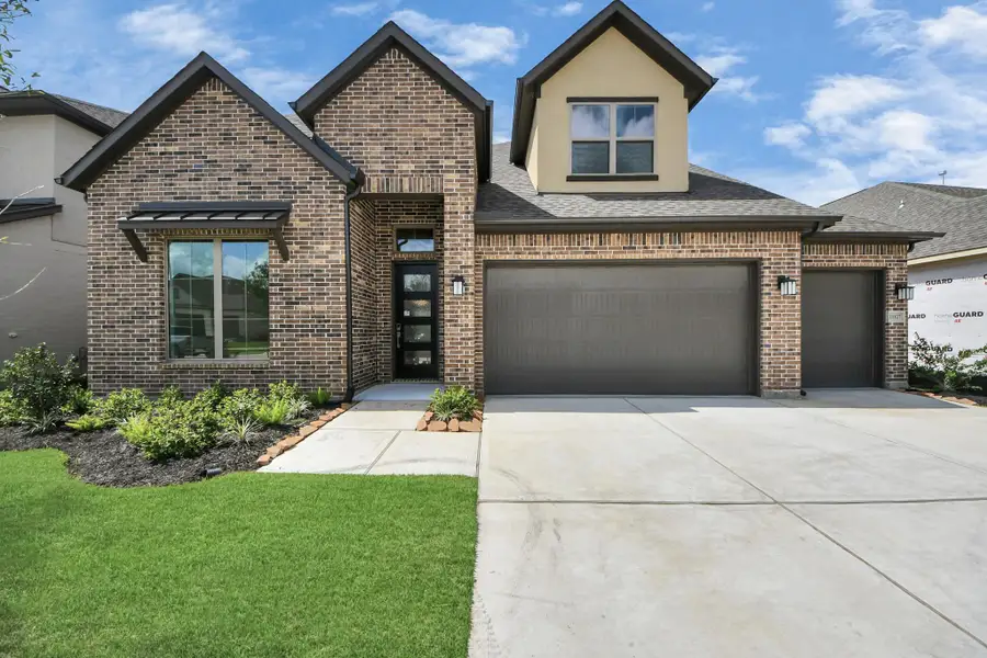 Front exterior of a new home in Marvida, Cypress, TX, highlighting curb appeal (Image 2).