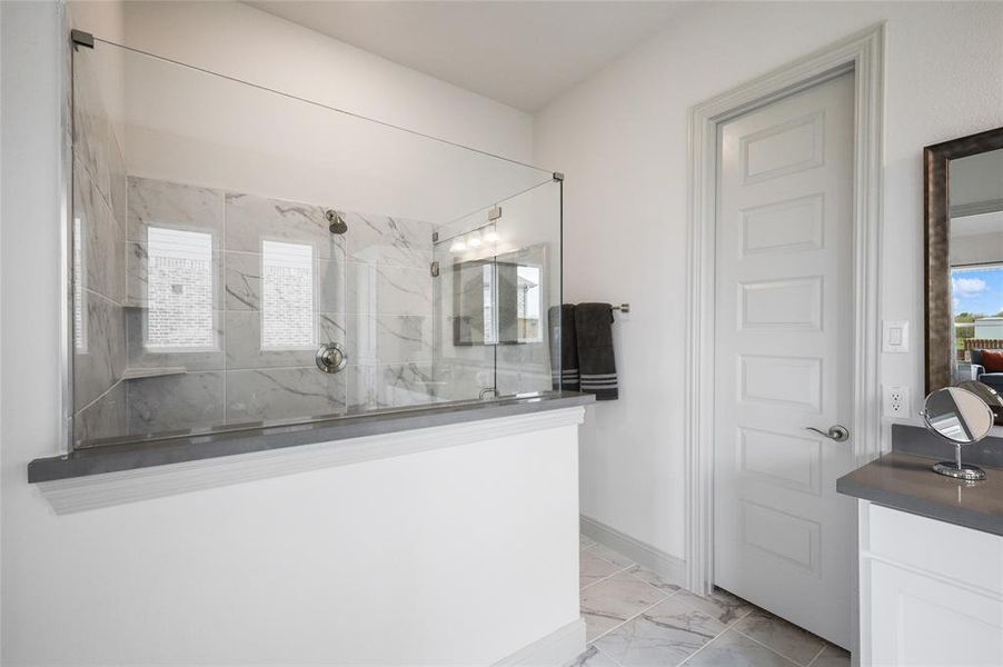 Bathroom with vanity and a shower