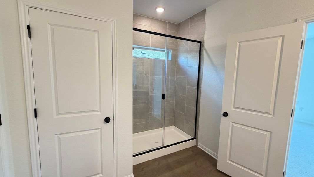 Modern walk-in shower with sleek glass enclosure and contemporary tilework. Modern walk-in shower with sleek glass enclosure and contemporary tilework.