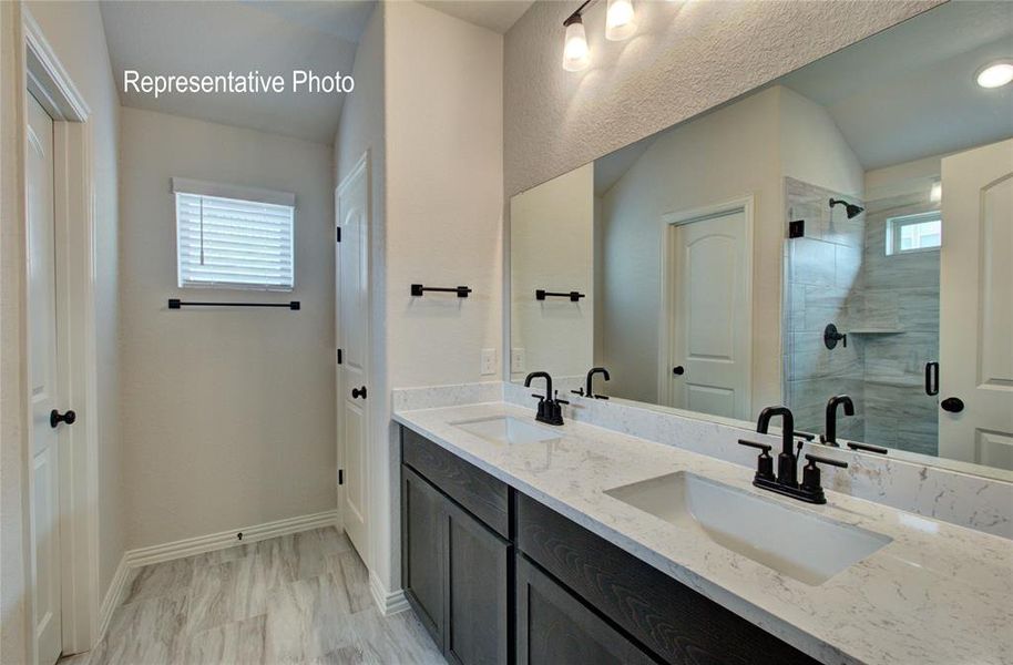 Dual vanity with stone-finish countertops, undermount sinks, and matte black fixtures