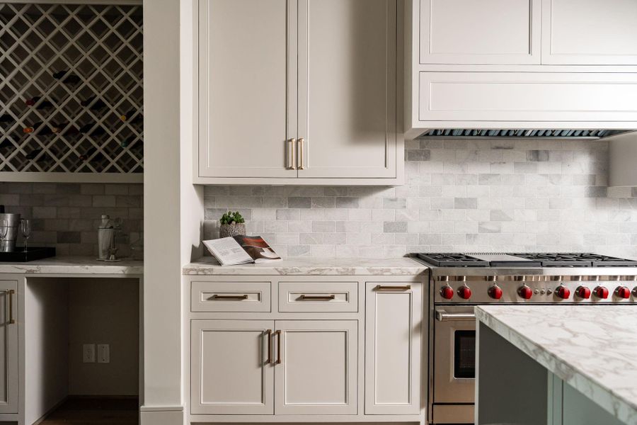 All the kitchen cabinets feature inset, soft-close doors and drawers. The drawers have undermount hardware to keep them quiet and fully accessible. The back splash is tumbled marble, giving a subtle contrast to the countertops of the same polished marble. All the kitchen cabinets feature inset, soft-close doors and drawers. The drawers have undermount hardware to keep them quiet and fully accessible. The back splash is tumbled marble, giving a subtle contrast to the countertops of the same polished marble.