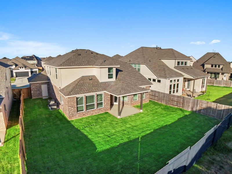 Another aerial backyard view displays the home’s generous lot, fenced yard, and the inviting combination of green space and privacy that makes outdoor living effortless. Another aerial backyard view displays the home’s generous lot, fenced yard, and the inviting combination of green space and privacy that makes outdoor living effortless.