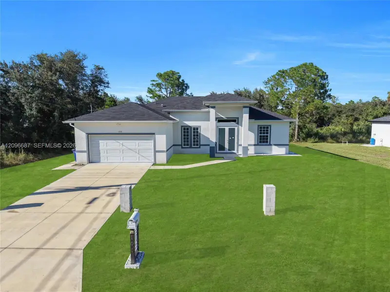 Front exterior of a new home in , Lehigh Acres, FL, highlighting curb appeal (Image 19).