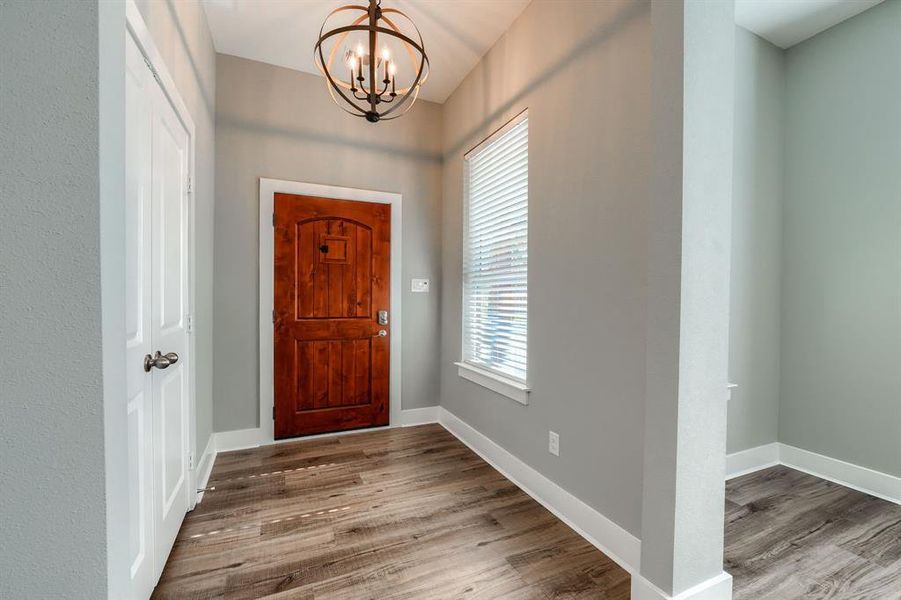 Foyer featuring a chandelier and dark hardwood / wood-style floors