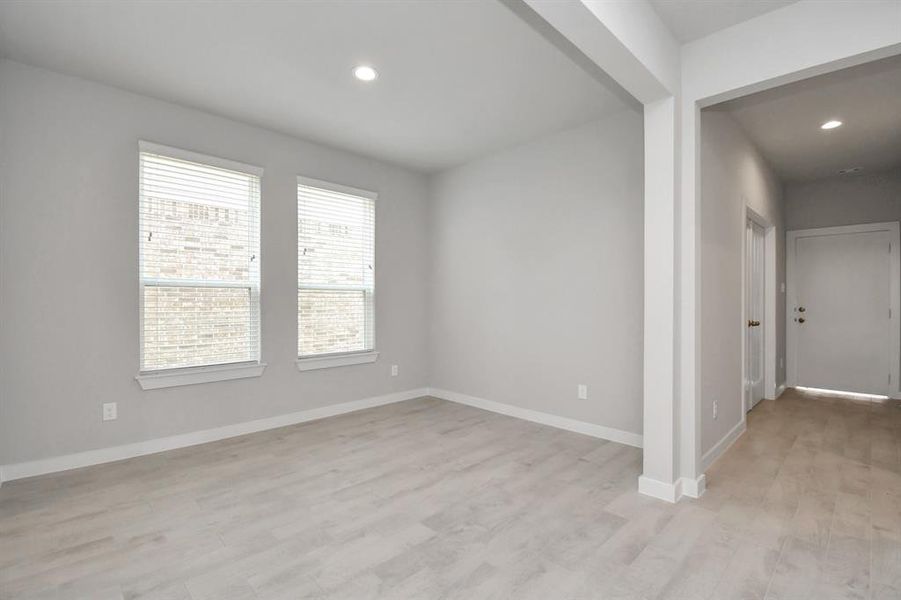 An inviting dining space seamlessly woven into the open concept, connecting the family room and kitchen. Revel in the stunning floors, soothing paint palette, and the crowning touch of bright recessed lighting – a perfect setting for shared meals and cherished moments.