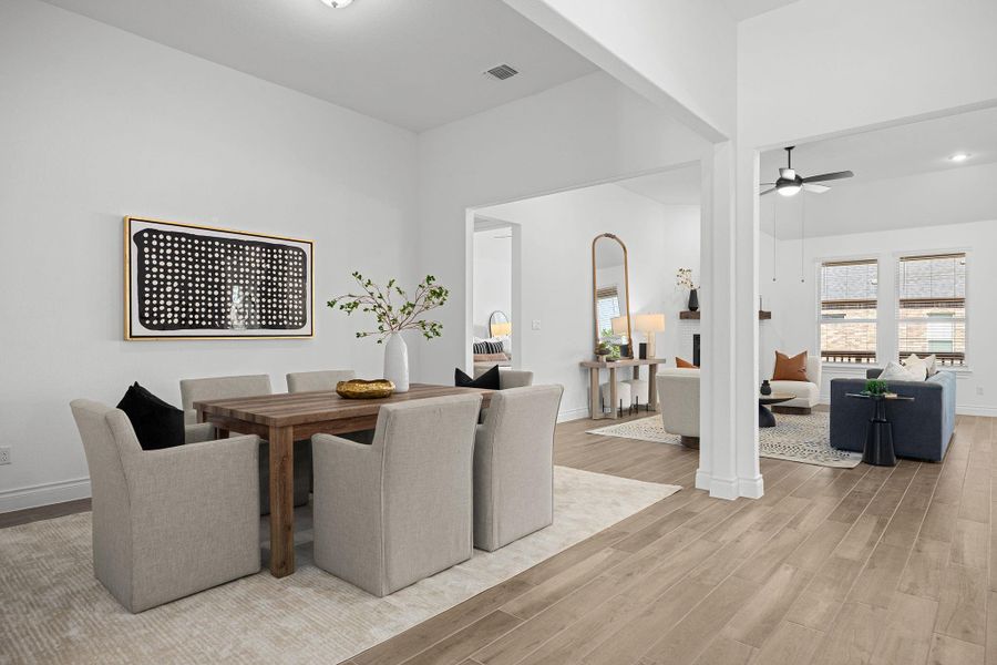 Dining space with light wood-style floors and ceiling fan