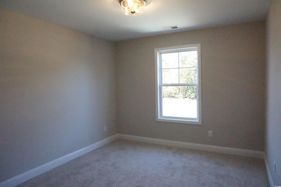 Spare room featuring carpet