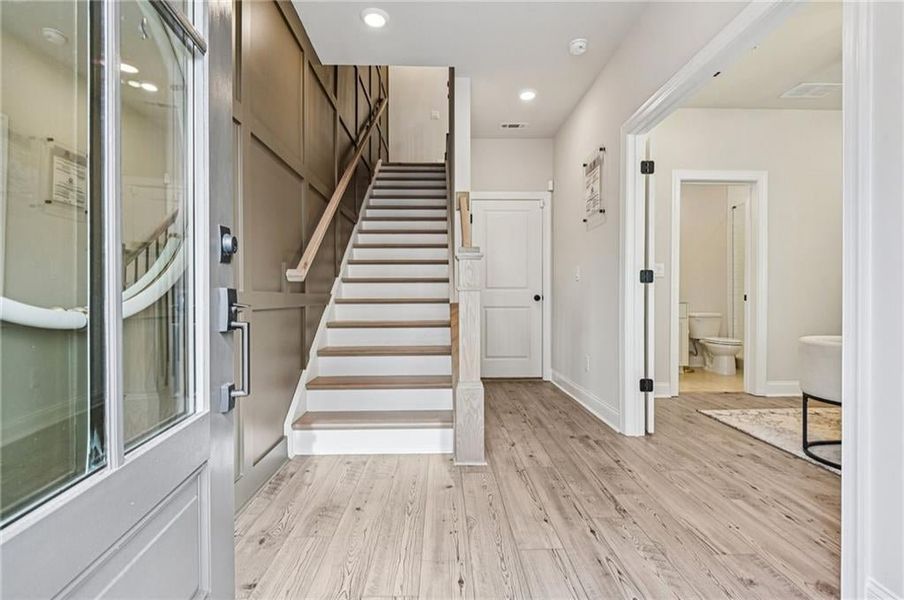 Entrance foyer featuring stairs, light wood-type flooring, and recessed lighting