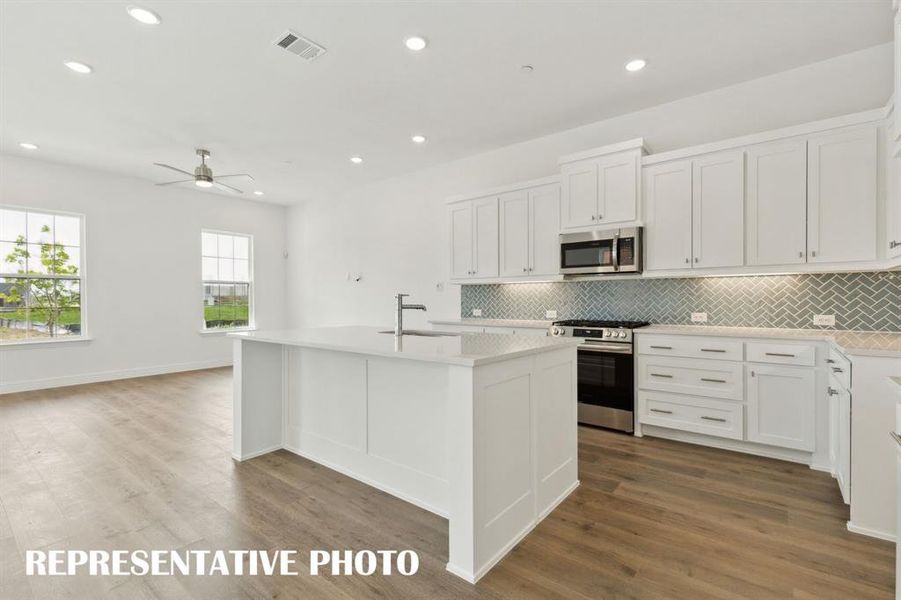 The spacious kitchen island is the perfect place for friends and family to gather!  REPRESENTATIVE PHOTO