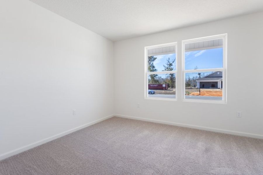 A room with a window and a white wall with a view of the water. A room with a window and a white wall with a view of the water.