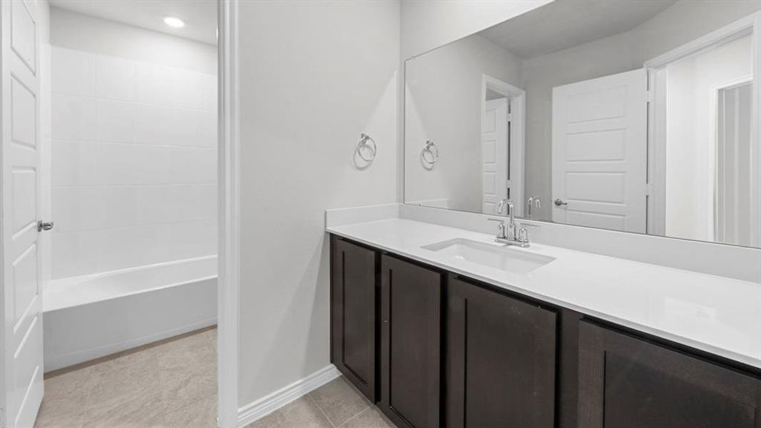 Bathroom featuring vanity and light tile patterned floors