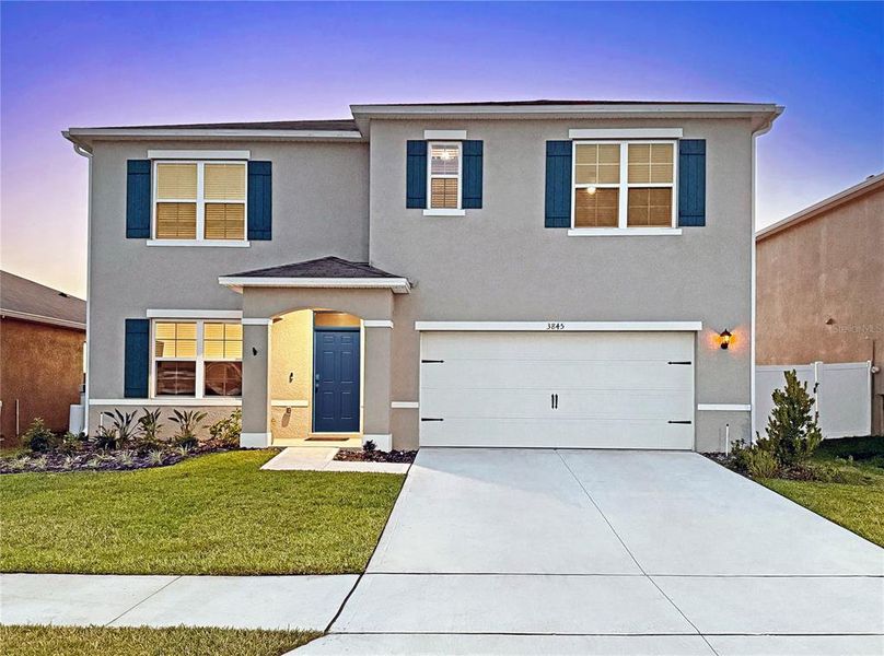 Front exterior of a new home in Lakes at Laurel Highlands, Lakeland, FL, highlighting curb appeal (Image 30).