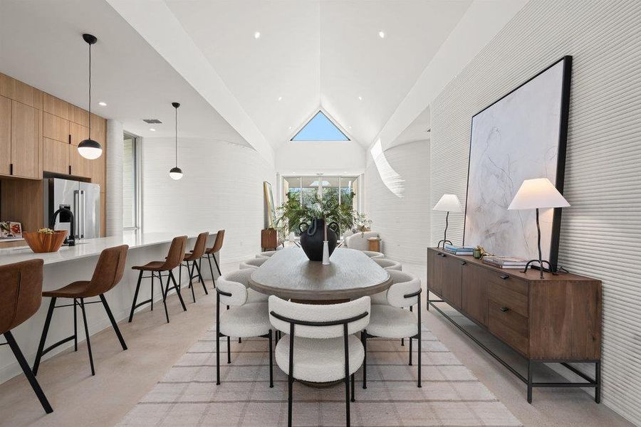 Dining room featuring vaulted ceiling and recessed lighting