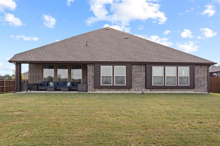 Rear view of house featuring a patio area, a yard, and outdoor lounge area