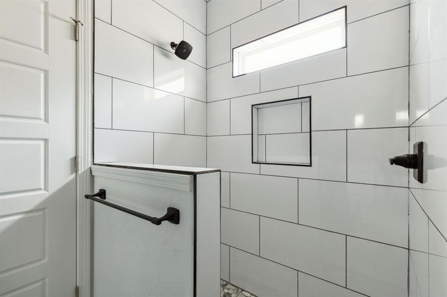 Bathroom featuring a tile shower