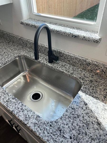 Kitchen view of light stone counters