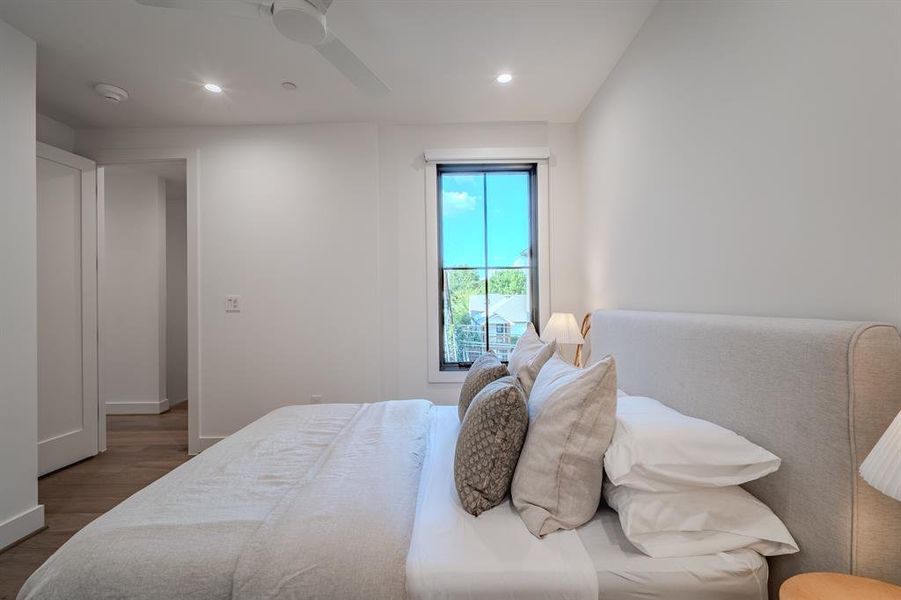 Bedroom featuring wood finished floors, recessed lighting, and a ceiling fan Bedroom featuring wood finished floors, recessed lighting, and a ceiling fan