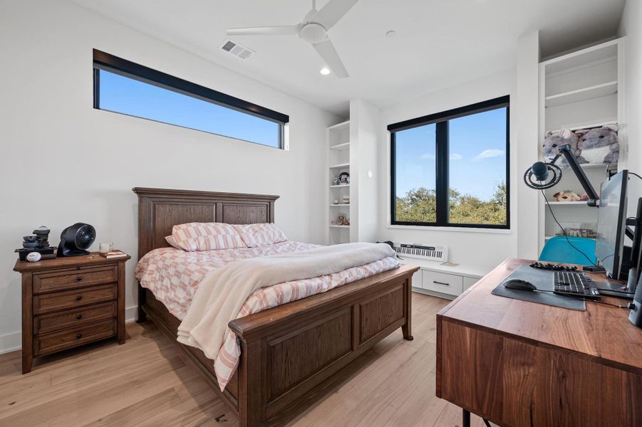 Bedroom with visible vents, baseboards, ceiling fan, recessed lighting, and light wood-style floors Bedroom with visible vents, baseboards, ceiling fan, recessed lighting, and light wood-style floors