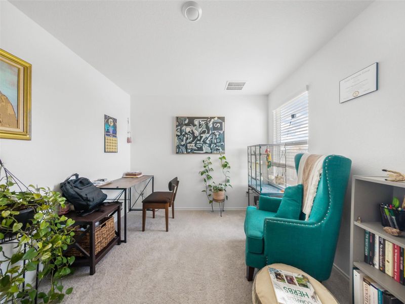 Living area featuring light colored carpet and baseboards