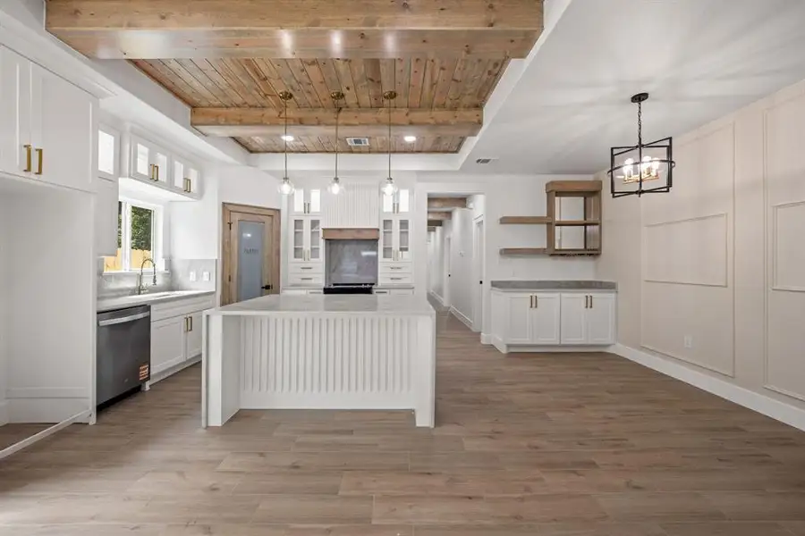 Open-concept kitchen and dining area with wood-finish flooring