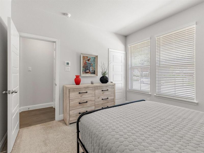 This view of the second bedroom emphasizes the generous layout and access to its own large walk-in closet.  There is also a large linen closet just outside the doorway.