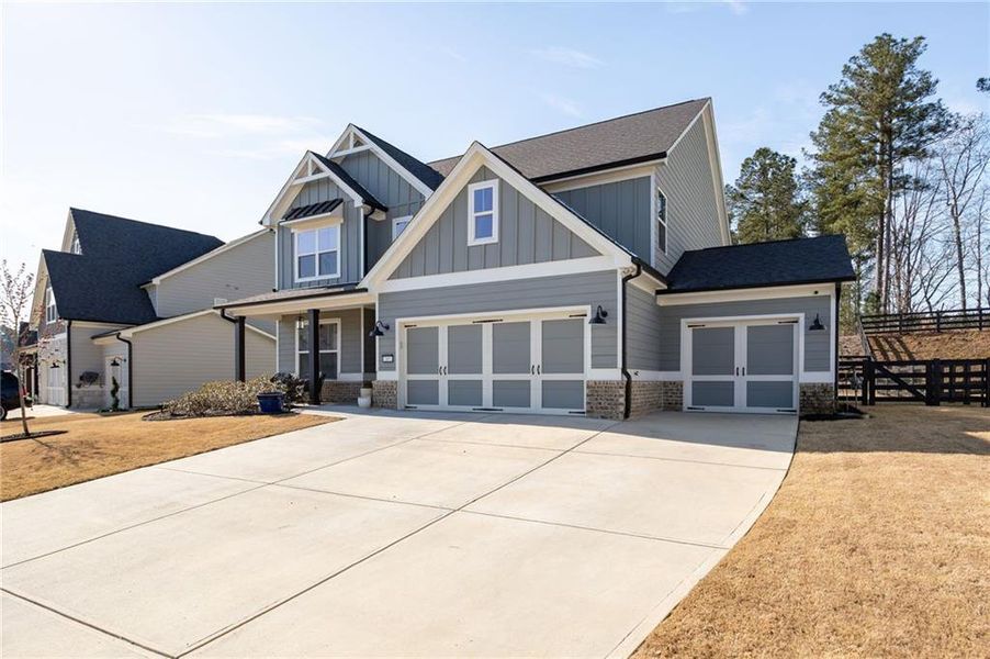 Front exterior of a new home in NorthFarm at NatureWalk, Dallas, GA, highlighting curb appeal (Image 22).