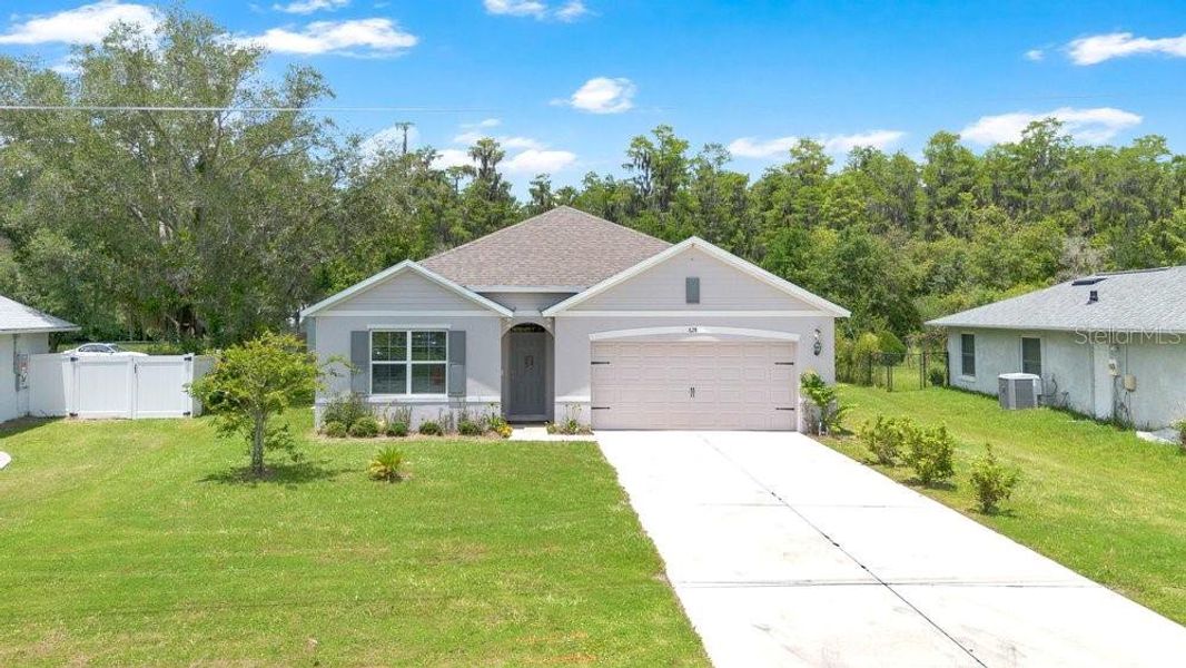 Front exterior of a new home in Poinciana Enclave, Poinciana, FL, highlighting curb appeal (Image 22).
