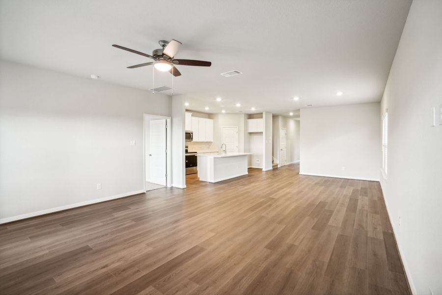 Living room and kitchen of the Reynolds floorplan at a Meritage Homes community.