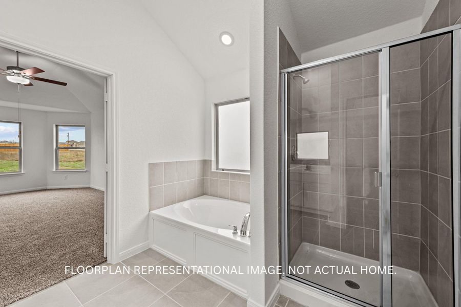 A well-appointed bathroom features a deep soaking tub and a separate glass-enclosed shower.