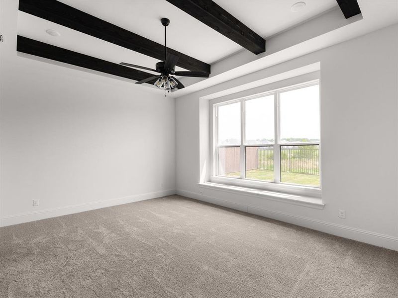 Unfurnished room featuring light carpet, beamed ceiling, and ceiling fan