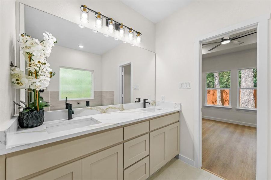 Dual vanity with light cabinetry, white countertops, and integrated rectangular sinks Dual vanity with light cabinetry, white countertops, and integrated rectangular sinks