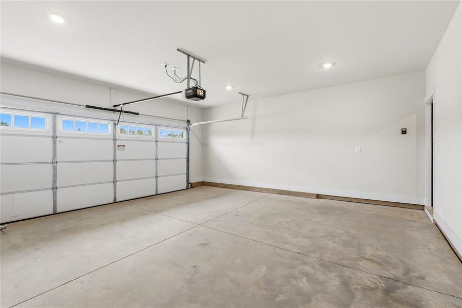 This spacious garage offers ample storage and dire