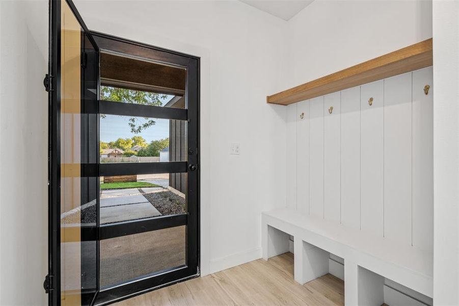 Mudroom with light hardwood / wood-style floors