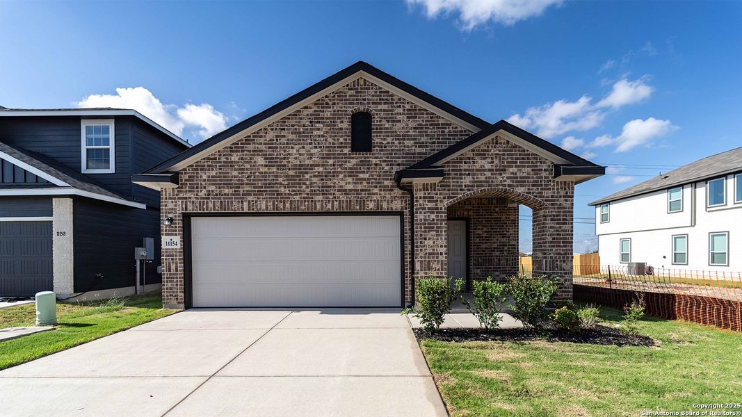 Front exterior of a new home in Katzer Ranch, Converse, TX, highlighting curb appeal (Image 1).