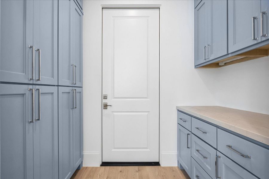 Off the kitchen is the pantry with excessive vertical cabinetry, as well as secondary space with countertop and cabinetry above to use as storage, additional prep space, or a dry bar area!