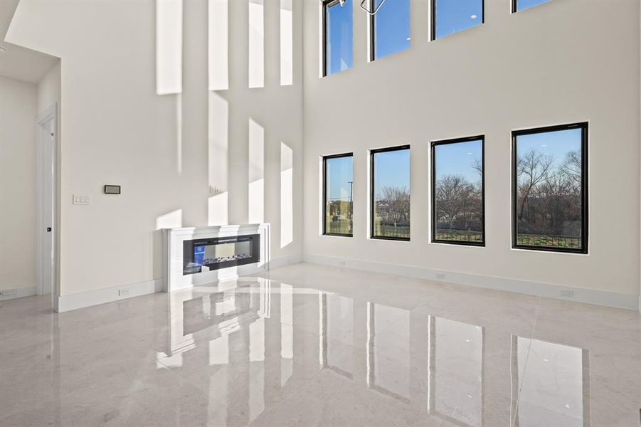 Unfurnished living room with a high ceiling