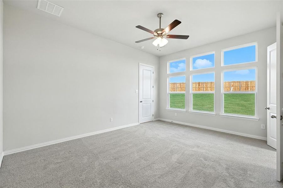 Spare room featuring carpet flooring and ceiling fan Spare room featuring carpet flooring and ceiling fan