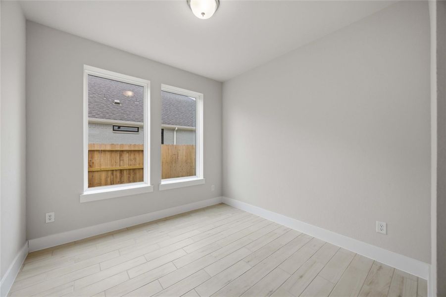 Spacious, unfurnished interior of a new home in Ellwood, Iowa Colony (Image 18).