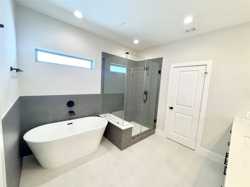 Huge soaking tub and large shower with seated area. Huge soaking tub and large shower with seated area.