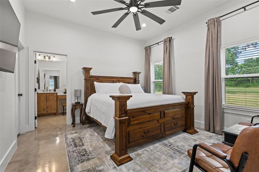Bedroom featuring concrete floors, recessed lighting, a ceiling fan, and ensuite bath