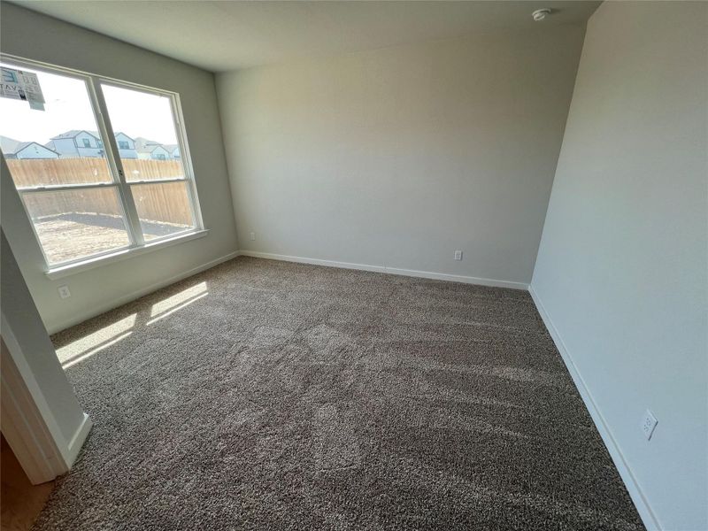 Carpeted spare room with baseboards